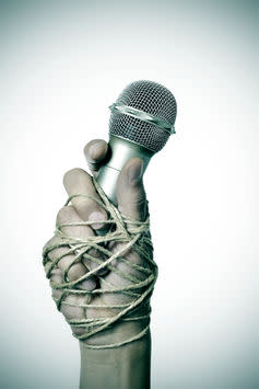 <span class="caption">Freedom of speech is not the same as freedom of thought.</span> <span class="attribution"><a class="link " href="https://www.shutterstock.com/image-photo/closeup-microphone-hand-young-man-tied-411388780?src=RJ6drK368eu9fzeWjjzSxA-3-50" rel="nofollow noopener" target="_blank" data-ylk="slk:Shutterstock;elm:context_link;itc:0;sec:content-canvas">Shutterstock</a></span>