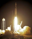 A SpaceX Falcon heavy rocket lifts off from pad 39A at the Kennedy Space Center in Cape Canaveral, Fla., early Tuesday, June 25, 2019. The Falcon rocket has a payload military and scientific research satellites. (AP Photo/John Raoux)