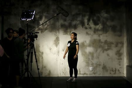 A participant is interviewed before the start of a workout session during TV program "The Body Show" at a gym in Seoul, September 19, 2015. REUTERS/Kim Hong-Ji