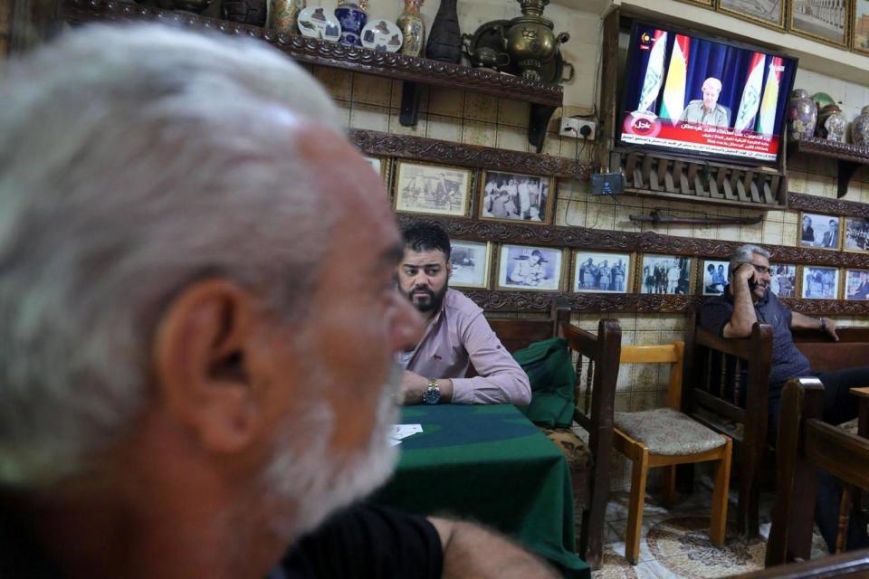 Baghdad: Iraqis sit at a popular coffee shop as a television screen is showing Masoud Barzani, the president of Kurdistan Region (EPA)