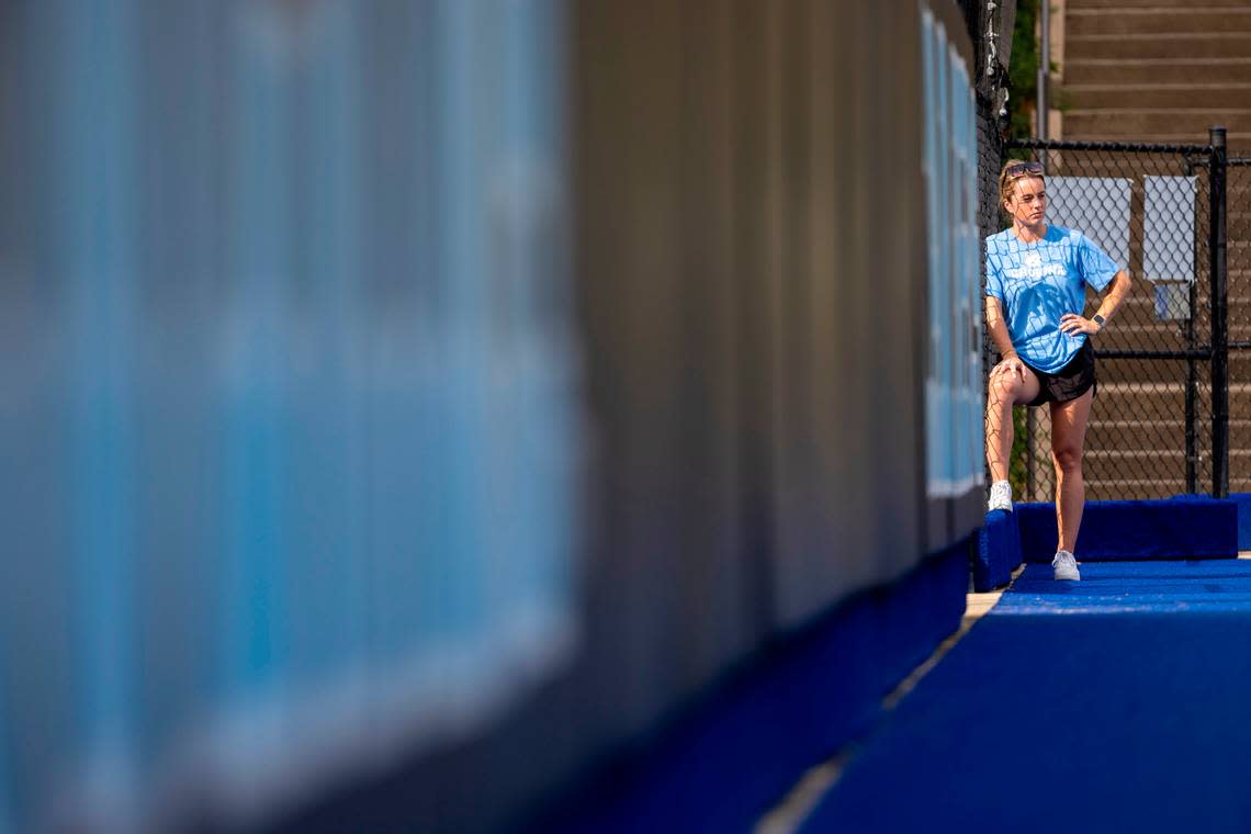 North Carolina field hockey coach Erin Matson talks with team communications director Dana Gelin, on the the other side of the fence, as she watches her players practice their penalty shots on Wednesday, September, 13, 2023 at Karen Shelton Stadium in Chapel Hill, N.C.