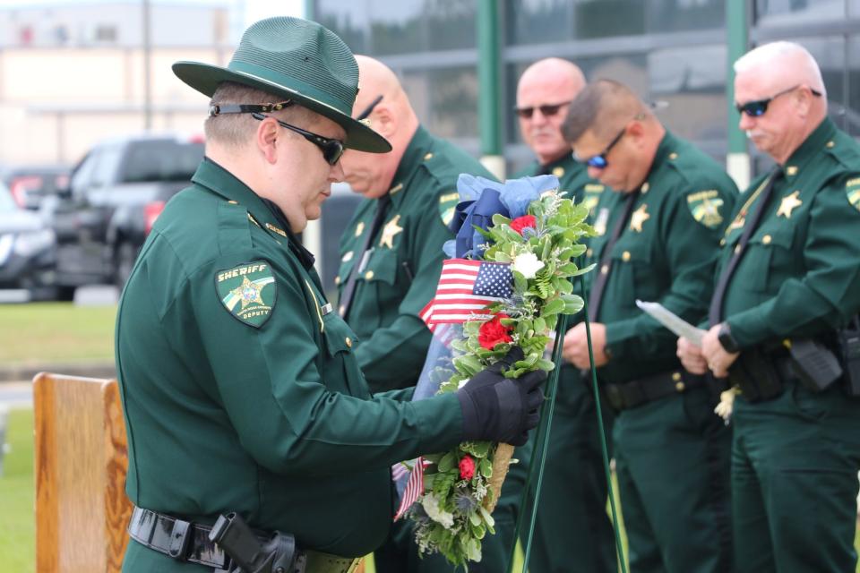 An SRSO deputy places a wreath during the department's annual ceremony to celebrate and honor fallen law enforcement officers.