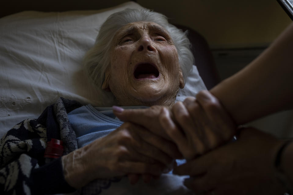 An elderly woman who has been evacuated from the Lysychansk area cries moments before departing by train to western Ukraine from the Pokrovsk railway station, Friday, June 10, 2022. (AP Photo/Bernat Armangue )