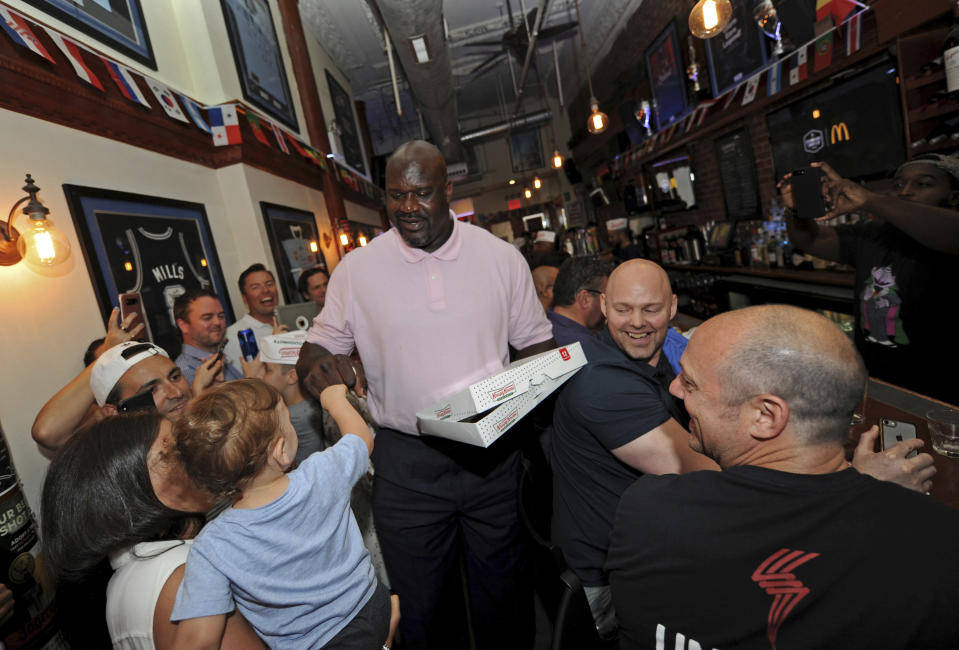 IMAGE DISTRIBUTED FOR KRISPY KREME DOUGHNUTS - Basketball Hall of Famer and Krispy Kreme Doughnuts global ambassador Shaquille O'Neal celebrates World Chocolate Day by surprising soccer fans with Krispy Kreme Chocolate Glaze Doughnuts, Friday, July 6, 2018 at The Australian pub in New York. Krispy Kreme is offering the rare doughnuts for one day only Saturday, July 7, 2018 – World Chocolate Day – at participating locations throughout the U.S. and on six continents. (Diane Bondareff/AP Images for Krispy Kreme Doughnuts)