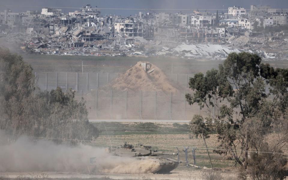 An Israeli tank manoeuvres along the Israel-Gaza border