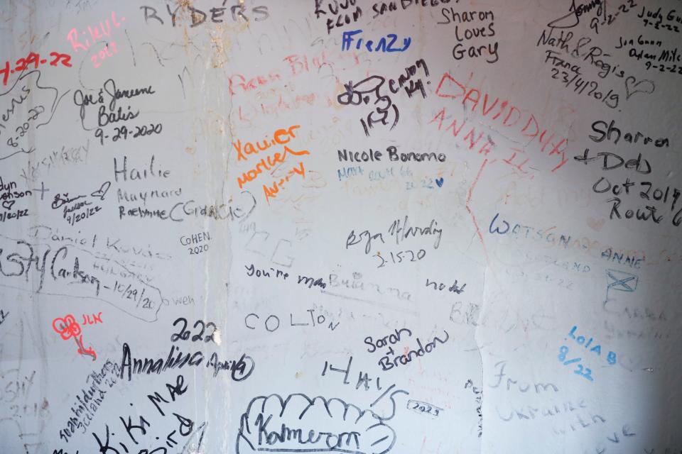 Visitors to the College Street Cafe can sign the walls.