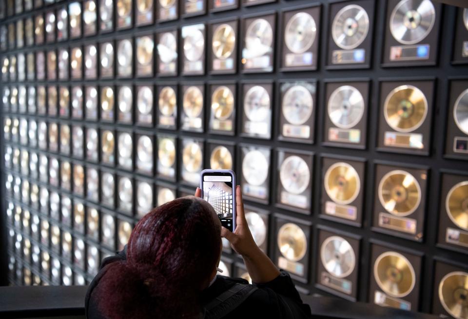 Armani Geter, accounting major, photographs the records displayed from floor to ceiling in the Country Music Hall of Fame in Nashville, Tenn., Tuesday, May 24, 2022.