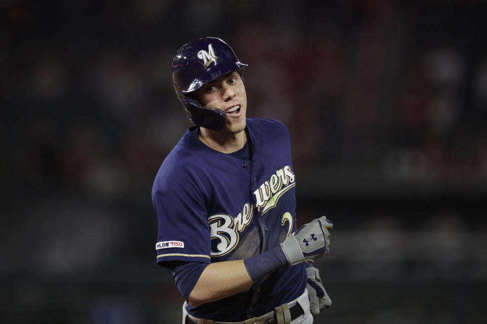 Milwaukee Brewers' Christian Yelich heads toward the dugout after he flew out to Los Angeles Angels center fielder Mike Trout during the third inning of a baseball game, Monday, April 8, 2019, in Anaheim, Calif. (AP Photo/Jae C. Hong)