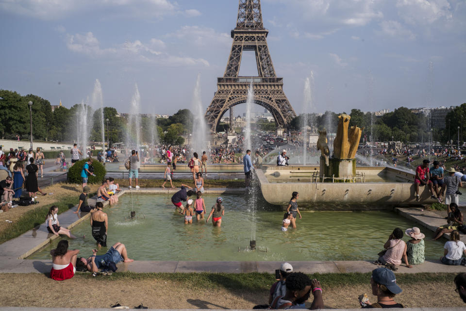 People cool off in the fountains of Paris' Trocadero gardens on July 25, 2019, when a new all-time high temperature of 108.7 degrees hit the French capital. (Photo: Rafael Yaghobzadeh/AP Photo)