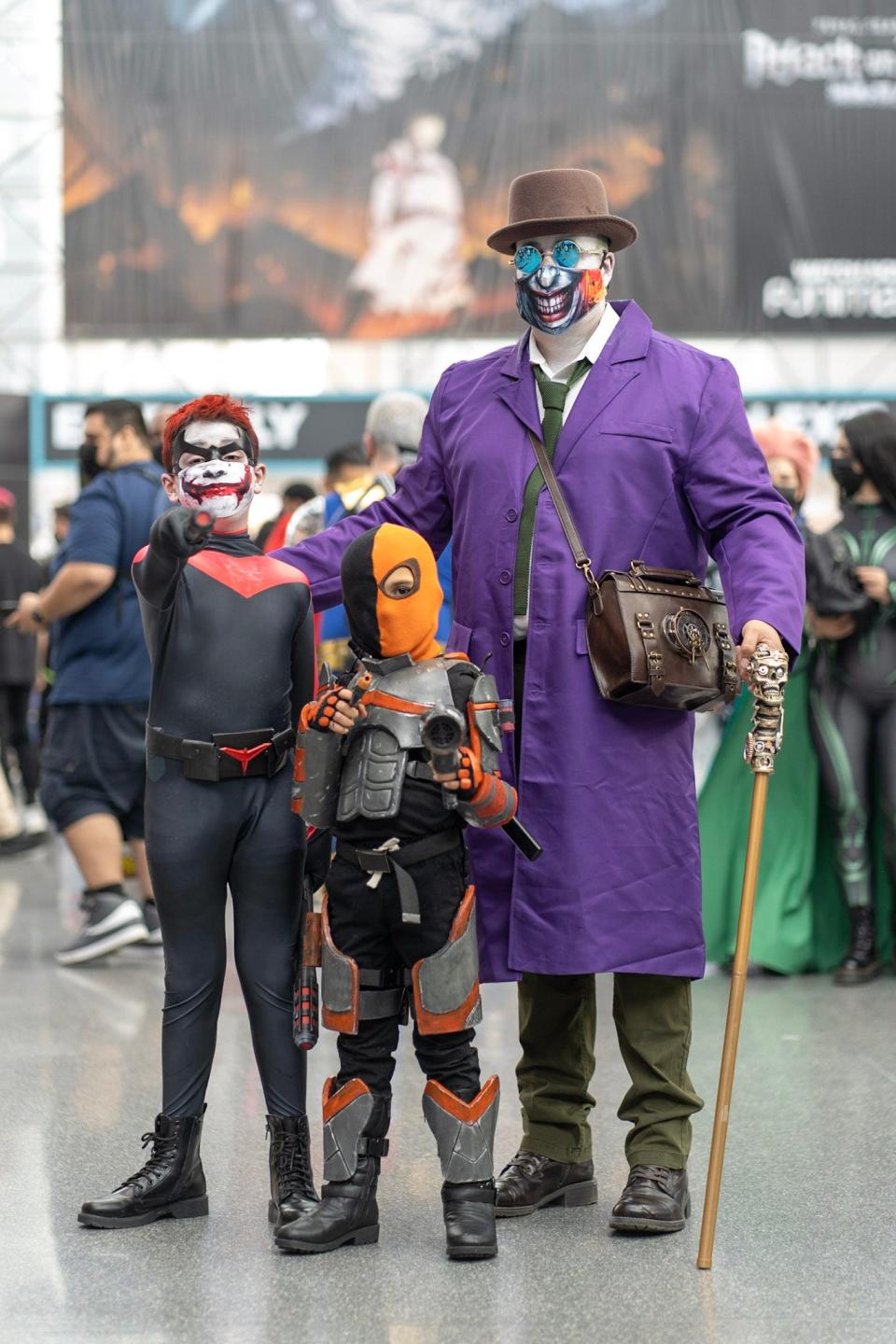 From left Cosplayers dressed as Nightwing Joker, Deathstroke, and Gaslight Joker at New York Comic Con 2021.