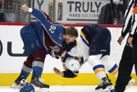 Colorado Avalanche left wing Gabriel Landeskog, left, fights with St. Louis Blues center Brayden Schenn in the first period of Game 1 of an NHL hockey Stanley Cup first-round playoff series Monday, May 17, 2021, in Denver. (AP Photo/David Zalubowski)