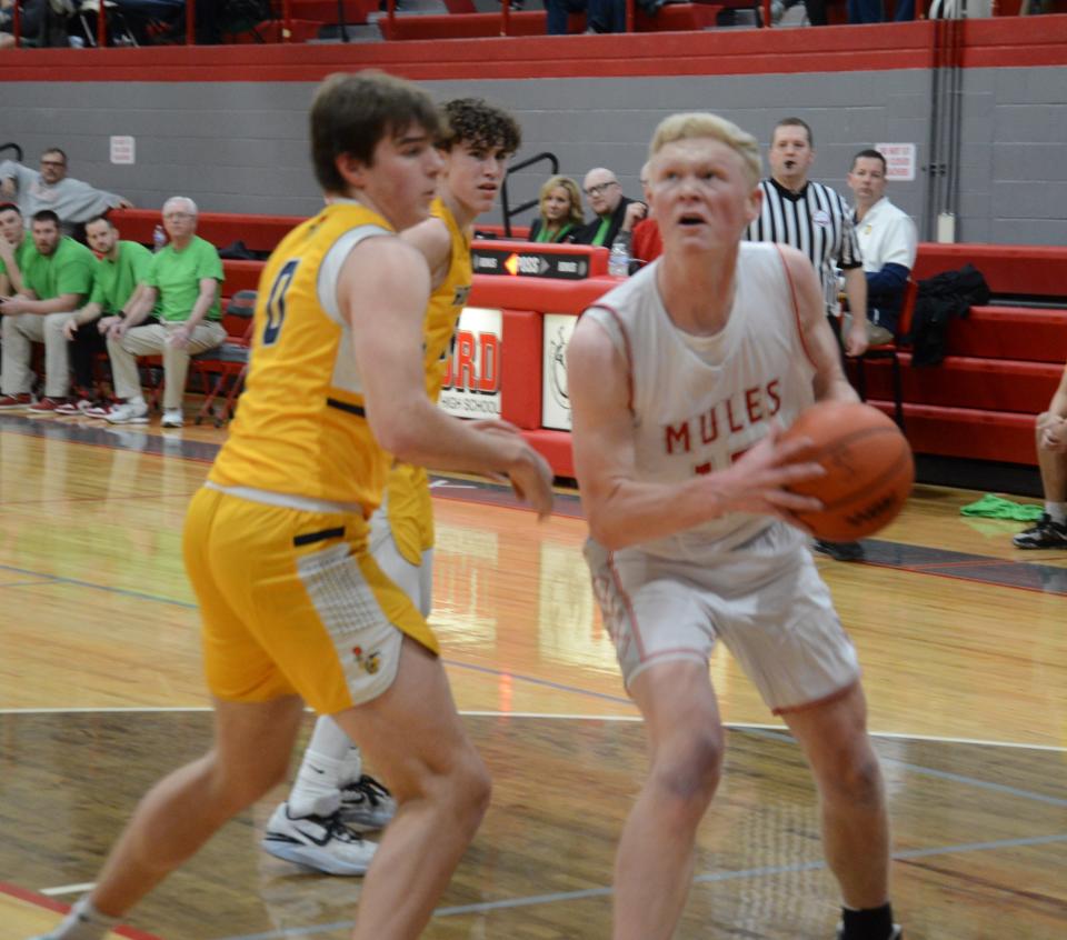 Bedford's Andrew Hollinger looks for a shot at Dylan Mesman defends for Saline during a 54-53 Bedford win Friday night.