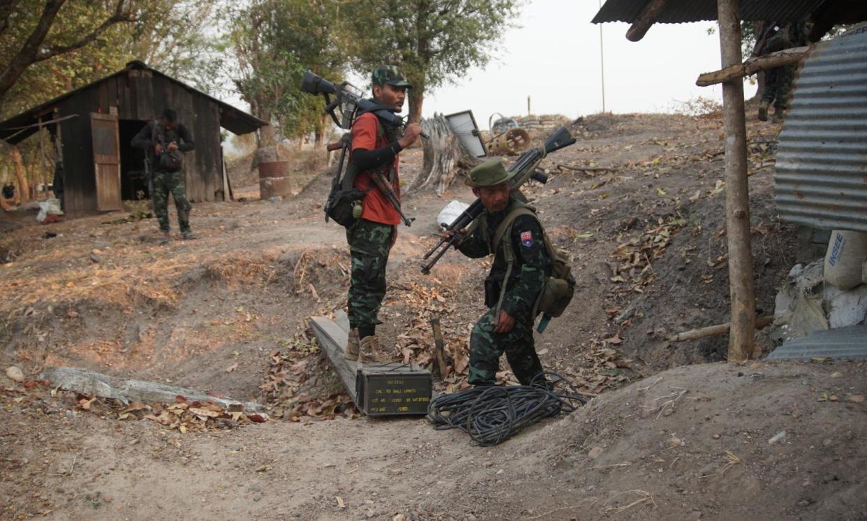 <span>Members of the Karen National Liberation Army and the People’s Defence Force collect weapons after they captured an army outpost in the southern part of Myawaddy township in Myanmar on 11 March.</span><span>Photograph: Noomna Nakhonphnom/AP</span>
