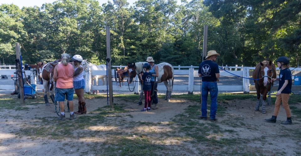 At the FIT Camp at Alliance Equestrian Center in Sandwich, families line up the horses after coming back from a trail walk on Aug. 3. Sophie Proe/Cape Cod Times