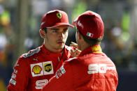 SINGAPORE, SINGAPORE - SEPTEMBER 21: Pole position qualifier Charles Leclerc of Monaco and Ferrari and third place qualifier Sebastian Vettel of Germany and Ferrari talk in parc ferme during qualifying for the F1 Grand Prix of Singapore at Marina Bay Street Circuit on September 21, 2019 in Singapore. (Photo by Mark Thompson/Getty Images)