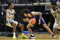 Northwestern guard Boo Buie, center, keeps the ball away from Purdue guard Eric Hunter Jr., left, in the second half of an NCAA college basketball game in West Lafayette, Ind., Sunday, Jan. 23, 2022. Purdue won 80-60. (AP Photo/AJ Mast)