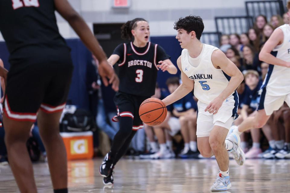 Franklin senior captain Justin Allen looks for an open teammate during the Division 1 Round of 16 MIAA tournament game against Brockton at Franklin High School on Mar. 07, 2023.