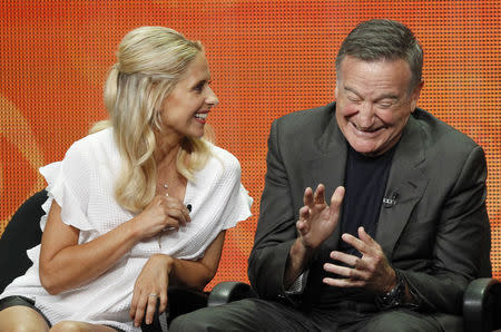 Cast member Robin Williams laughs next to co-star Sarah Michelle Gellar at a panel for the television series "The Crazy Ones" during the CBS portion of the Television Critics Association Summer press tour in Beverly Hills, California July 29, 2013. REUTERS/Mario Anzuoni