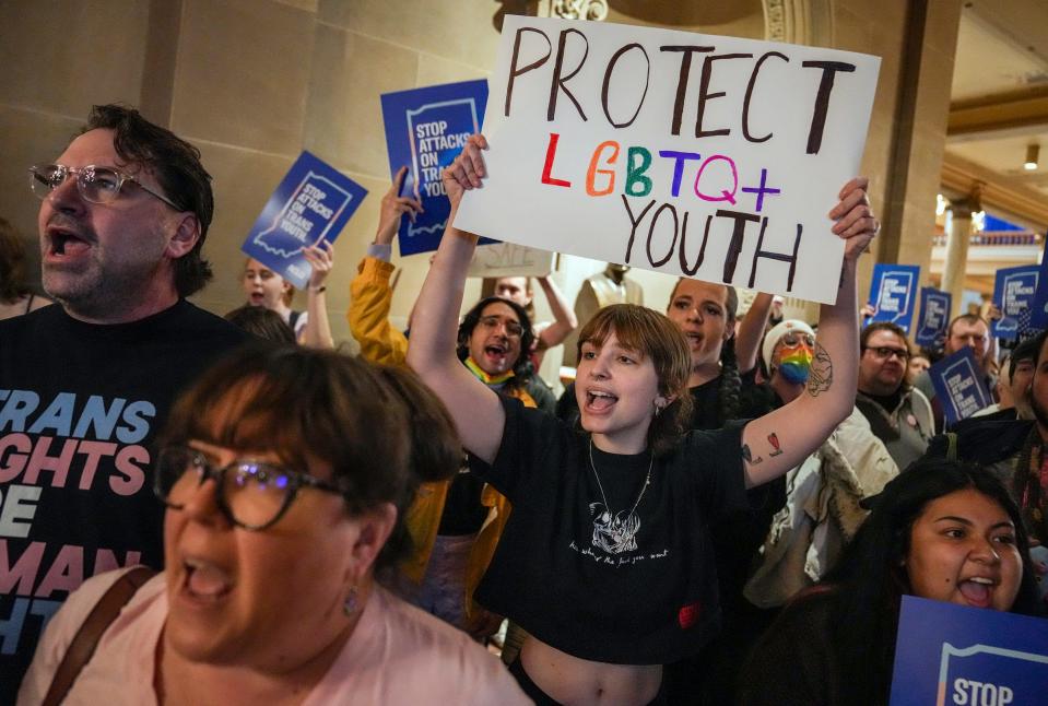 Eliza Housman (center) and others protest outside the Indiana Senate Chamber on Wednesday, Feb. 22, 2023, as the Senate Health and Provider Services Committee hears SB 480 at the Statehouse in Indianapolis. The bill, which passed committee 8-3, would ban gender-affirming medical or surgical treatment for minors.