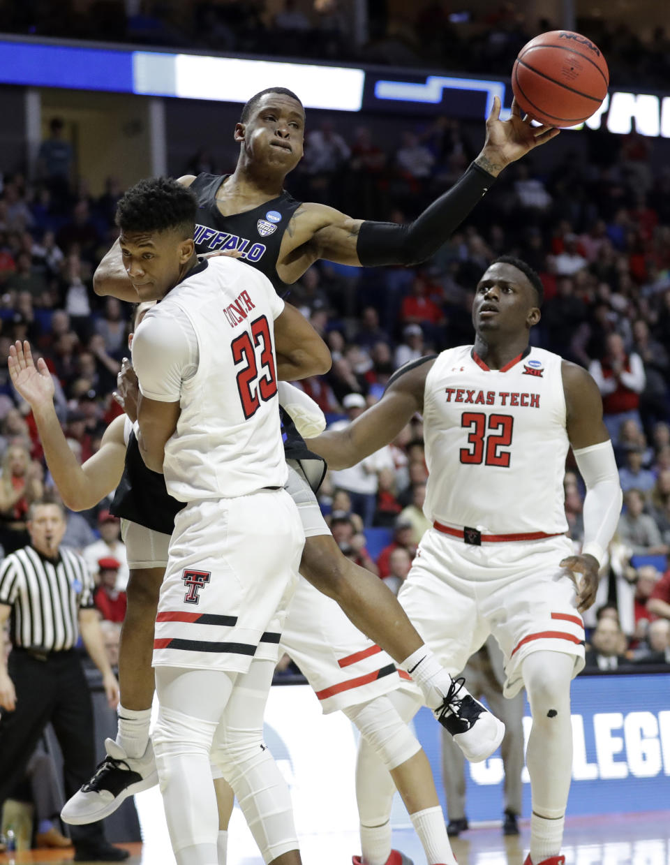 Buffalo's Davonta Jordan passes around Texas Tech's Jarrett Culver (23) and Norense Odiase during the second half of a second round men's college basketball game in the NCAA Tournament Sunday, March 24, 2019, in Tulsa, Okla. (AP Photo/Jeff Roberson)