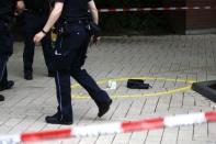 A police officer walks past crime scene after a knife attack in a supermarket in Hamburg, Germany. One person was killed and several were injured in an attack by a lone knifeman in a supermarket in the northern German city on Friday, police said. REUTERS/Morris Mac Matzen