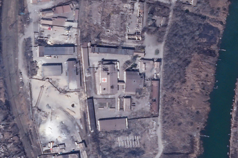 In this satellite photo from Planet Labs PBC, an International Committee of the Red Cross warehouse is seen with apparent damage from shelling in Mariupol, Ukraine, Monday, March 28, 2022. The Red Cross warehouse in the besieged Ukrainian port city of Mariupol has been struck amid intense Russian shelling of the area. The Red Cross said it distributed all the supplies from inside the warehouse earlier in March and no staff have been at the site since March 15. (Planet Labs PBC via AP)