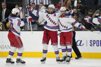 New York Rangers center Mika Zibanejad, center, celebrates after scoring against the Vegas Golden Knights during the third period of an NHL hockey game Wednesday, Dec. 7, 2022, in Las Vegas. (AP Photo/John Locher)