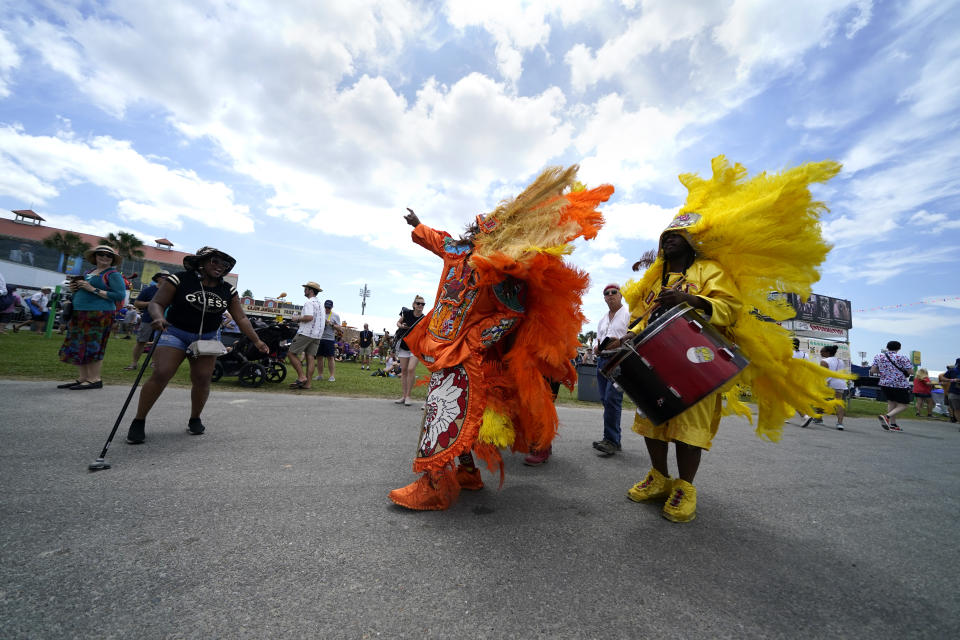 Members of the New Orleans Mardi Gras Indian tribe Wild Mohicans, parades through the New Orleans Jazz & Heritage Festival in New Orleans, Friday, April 29, 2022. (AP Photo/Gerald Herbert)