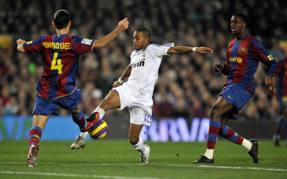 Real Madrid's Robinho takes on Rafael Marquez and Yaya Toure of Barcelona at the Nou Camp in 2007 - AFP