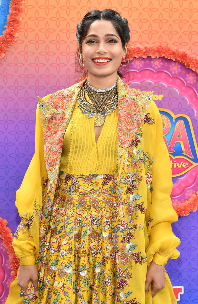 Freida Pinto attends the premiere of Disney Junior's "Mira, Royal Detective" in a brightly-colored dress and matching duster