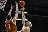 Tennessee forward Olivier Nkamhoua shoots over Texas forward Dylan Disu (1) during the first half of an NCAA college basketball game Saturday, Jan. 28, 2023, in Knoxville, Tenn. (AP Photo/Wade Payne)