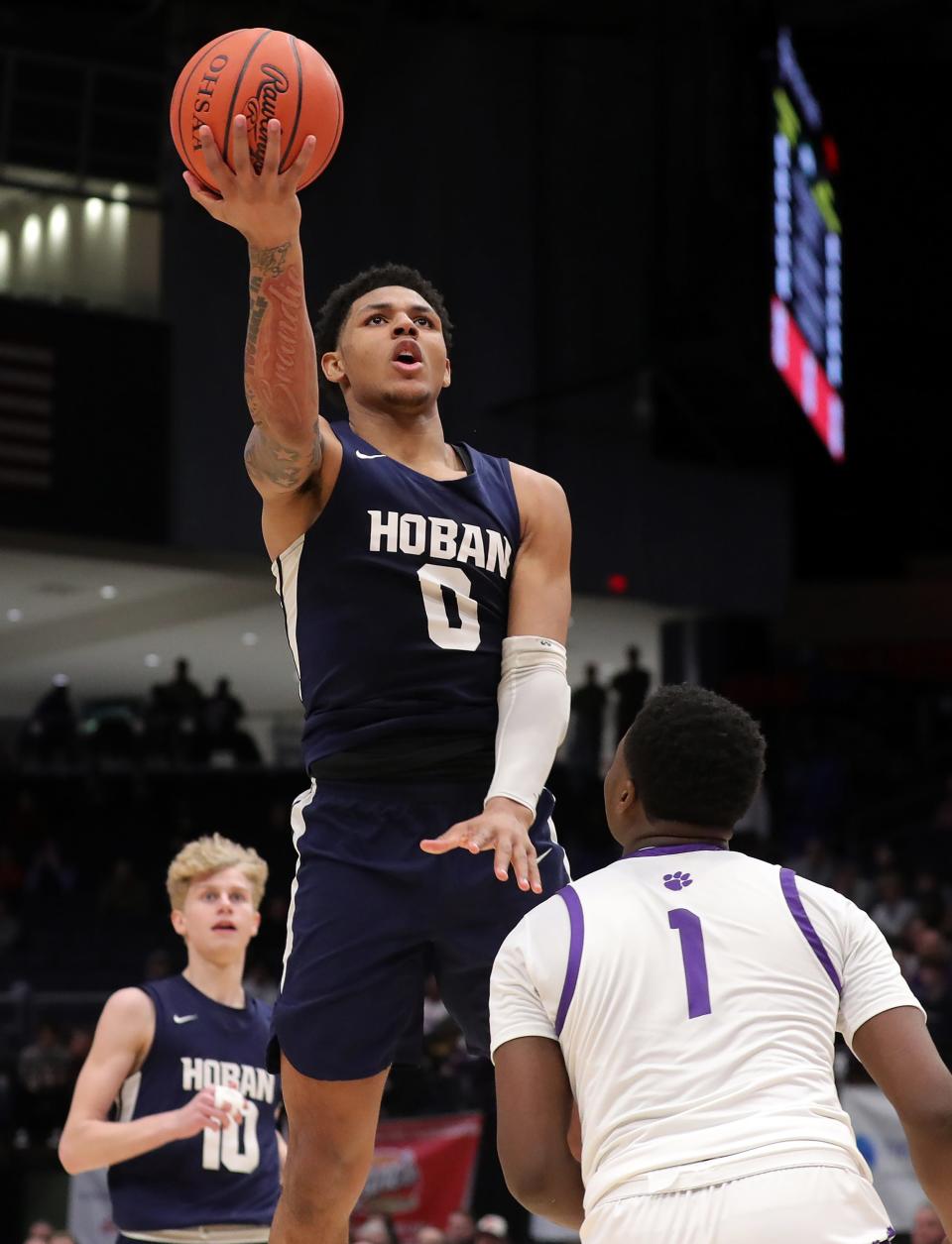 Hoban guard Jonas Nichols, top, looks for a layup over Pickerington Central guard Juwan Turner during the OHSAA Division I state championship game March 19 in Dayton.