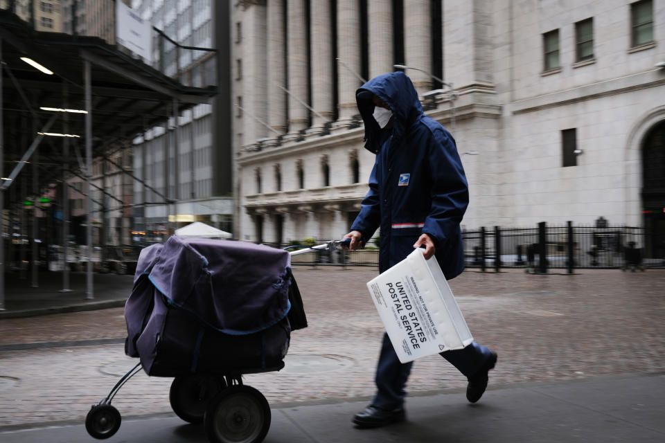 NEW YORK, NY - MAY 08: A mail carrier walks along Wall Street as the coronavirus keeps financial markets and businesses mostly closed on May 08, 2020 in New York City. The Bureau of Labor Statistics announced on Friday that the US economy lost 20.5 million jobs in April. This is the largest decline in jobs since the government began tracking the data in 1939.    (Photo by Spencer Platt/Getty Images)