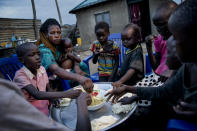 Paska Itwari Beda, the young mother of five children, shares a meal with her family at her Juba, South Sudan home, Thursday, May 27, 2021. The young mother of five children - all of them under age 10 - sometimes survives on one bowl of porridge a day, and her entire family is lucky to scrape together a single daily meal, even with much of the money Beda makes cleaning offices going toward food. (AP Photo/Adrienne Surprenant)