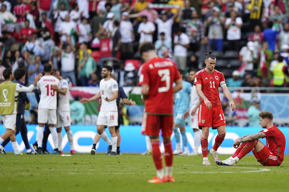 Wales' Gareth Bale, second from right, with teammate at the end of the World Cup group B soccer match between Wales and Iran, at the Ahmad Bin Ali Stadium in Al Rayyan , Qatar, Friday, Nov. 25, 2022. (AP Photo/Pavel Golovkin)