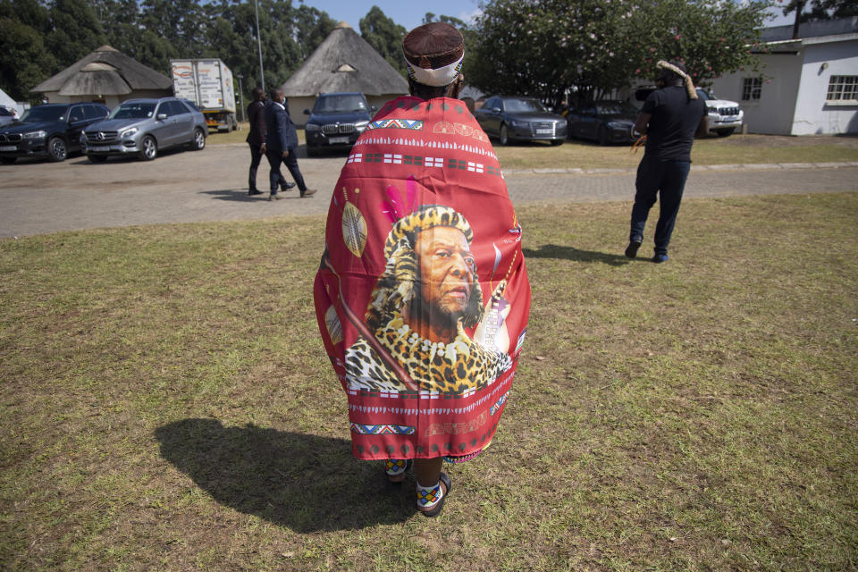 A woman wears a portrait of the late Zulu King Goodwill Zwelithini during the memorial service for the monarch in Nongoma, South Africa, Thursday, March 18, 2021. Zwelithini passed away last Friday after a reign that spanned more than 50 years. (AP Photo/Phill Magakoe)