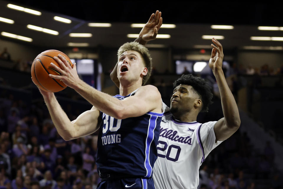 BYU guard Dallin Hall (30) attempts to score as Kansas State forward Jerrell Colbert (20) defends during the first half of an NCAA college basketball game, Saturday, Feb. 24, 2024, in Manhattan, Kan. (AP Photo/Colin E. Braley)