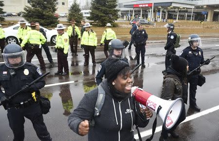 A protester named Oluchi of Minneapolis speaks to protesters after they shut down the main road to the Minneapolis St. Paul Airport following a short protest at the Mall of America in Bloomington, Minnesota December 23, 2015. REUTERS/Craig Lassig