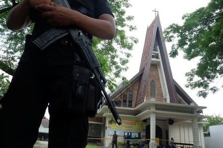 Police are seen outside Saint Joseph's Catholic Church after a suspected terror attack by a knife-wielding assailant on a priest during Sunday service in Medan, North Sumatra, Indonesia August 28, 2016 in this photo taken by Antara Foto. Picture taken August 28, 2016.Antara Foto/Irsan Mulyadi/ via REUTERS