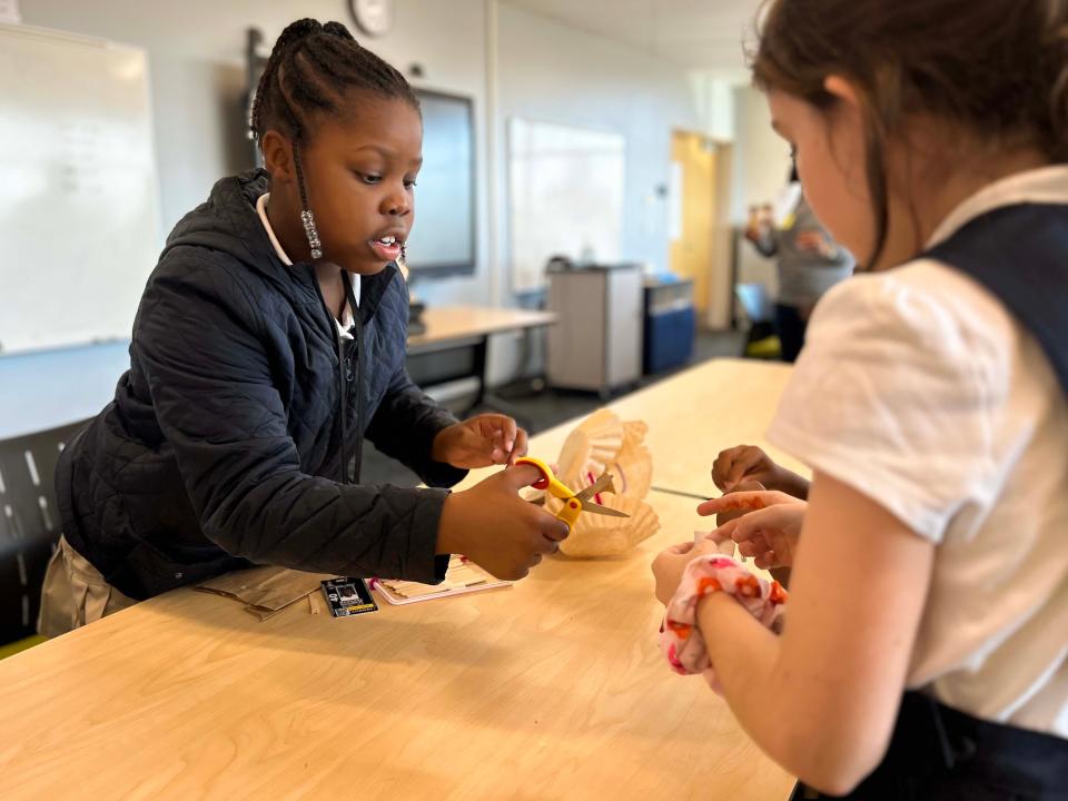 Third grade students work on a paper parachute they’ve built as part of an engineering exercise at A.J. Whittenberg Elementary School of Engineering.