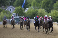 Flavien Prat atop Rombauer, second from right, leads the pack before winning the Preakness Stakes horse race at Pimlico Race Course, Saturday, May 15, 2021, in Baltimore. (AP Photo/Nick Wass)