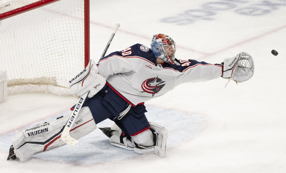 Columbus Blue Jackets goaltender Daniil Tarasov stretches for the puck during the third period of the team's NHL hockey game against the Montreal Canadiens on Tuesday, March 12, 2024, in Montreal. (Christinne Muschi/The Canadian Press via AP)