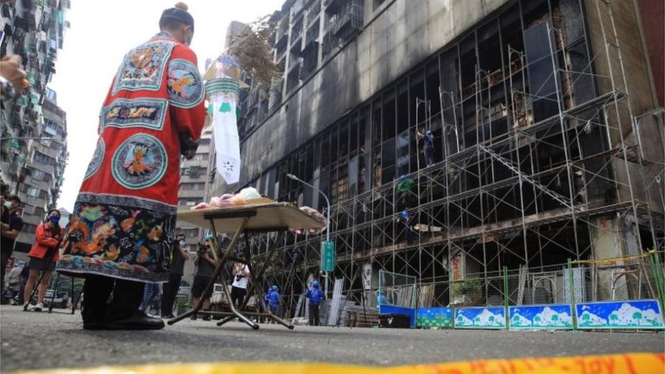 A Taoist priest holds a ceremony for the victims after a fire broke out in a residential building in Kaohsiung, Taiwan October 15, 2021. REUTERS/I-Hwa Cheng