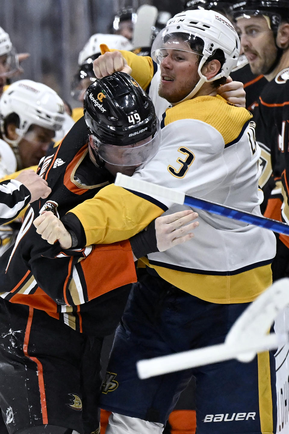 Nashville Predators defenseman Jeremy Lauzon (3) fights with Anaheim Ducks left wing Max Jones (49) during the second period of an NHL hockey game in Anaheim, Calif., Sunday, March 12, 2023. (AP Photo/Alex Gallardo)