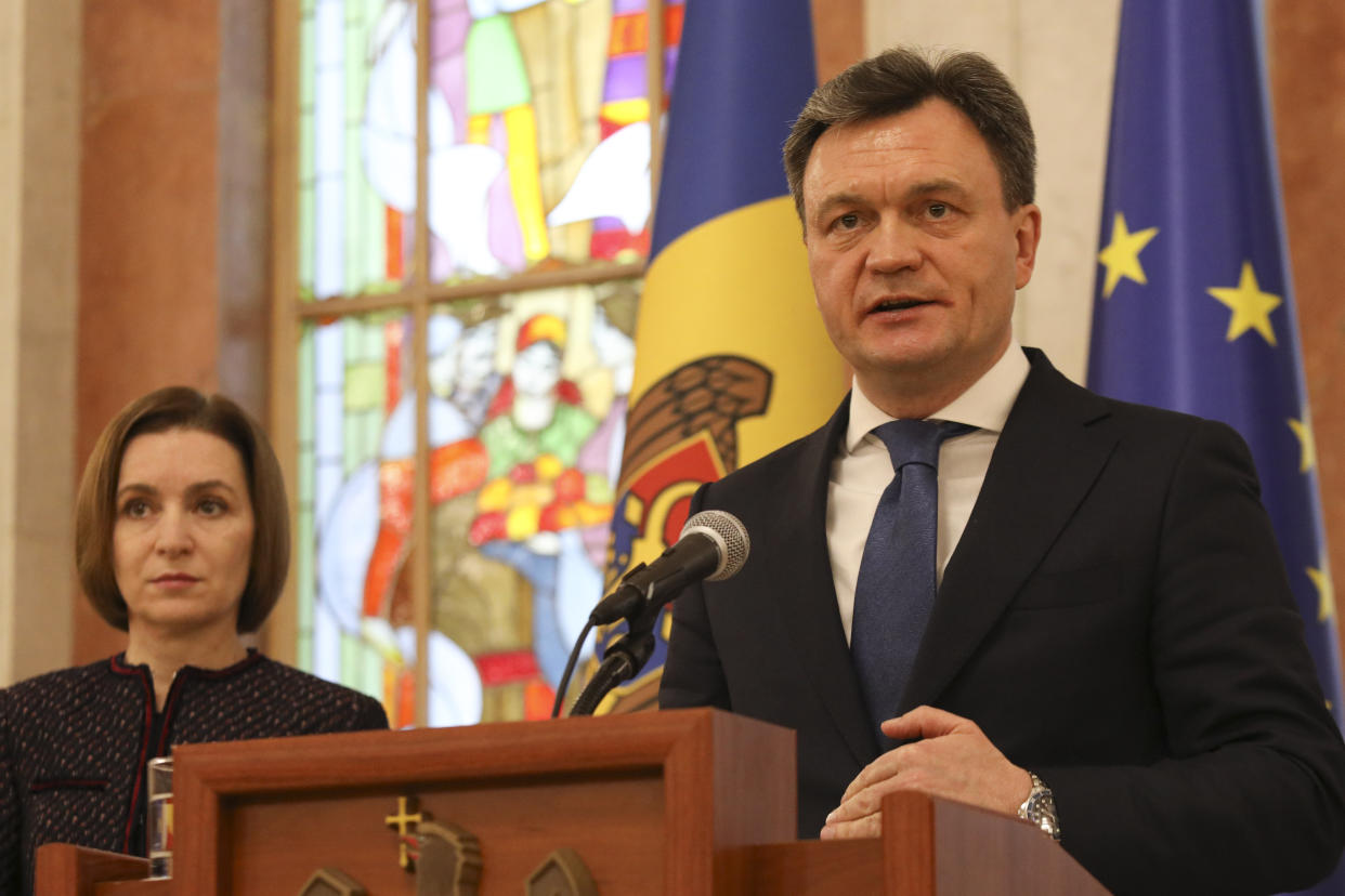 Moldovan Prime Minister-designate Dorin Recean at the microphone, with President Sandu to his right..