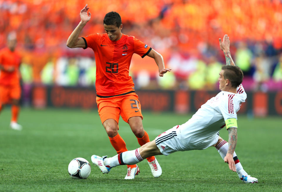 KHARKOV, UKRAINE - JUNE 09: Daniel Agger of Denmark tackles Ibrahim Afellay of Netherlands during the UEFA EURO 2012 group B match between Netherlands and Denmark at Metalist Stadium on June 9, 2012 in Kharkov, Ukraine. (Photo by Ian Walton/Getty Images)
