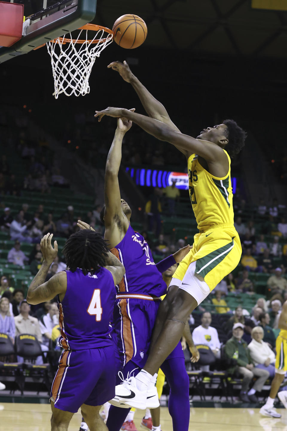 Baylor center Yves Missi, right, is fouled by Northwestern State forward Justin Wilson during the first half of an NCAA college basketball game Saturday, Dec. 2, 2023, in Waco, Texas. (AP Photo/Jerry Larson)