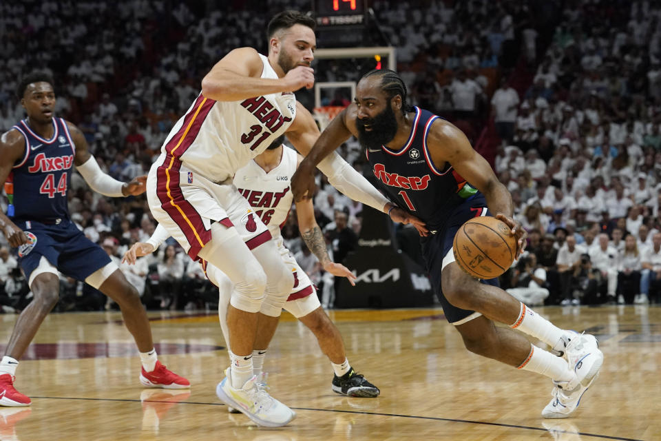 Philadelphia 76ers guard James Harden (1) drives to the basket as Miami Heat guard Max Strus (31) defends, during the first half of Game 1 of an NBA basketball second-round playoff series, Monday, May 2, 2022, in Miami. (AP Photo/Marta Lavandier)