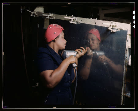 A woman operates a hand drill on a "Vengeance" dive bomber at Vultee Aircraft in Nashville, Tennessee in this February 1943 Library of Congress handout photo obtained by Reuters January 28, 2016. REUTERS/Alfred T. Palmer/Farm Security Administration - Office of War Information Collection/Library of Congress/Handout via Reuters