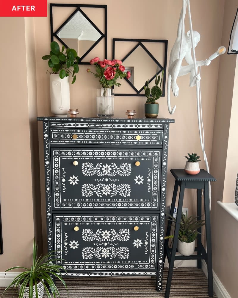 Hanging monkey lamp in front of stenciled dresser.